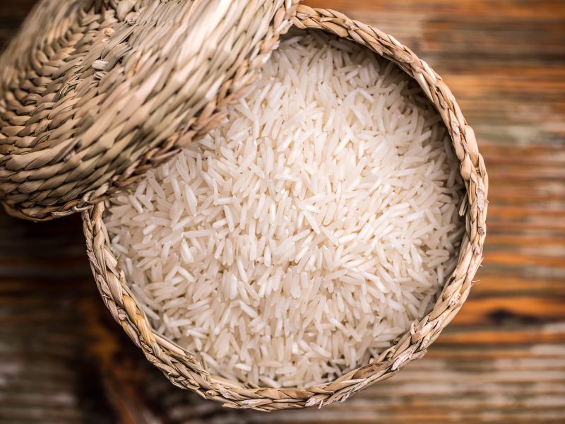 Top view of long grain rice in a wicker basket